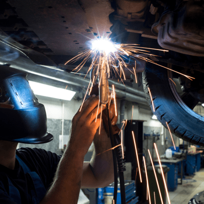 Car Muffler repair being performed by a mechanic at CSautos, serving Montreal, Laval, and Rive-Sud, with a focus on professional automotive services